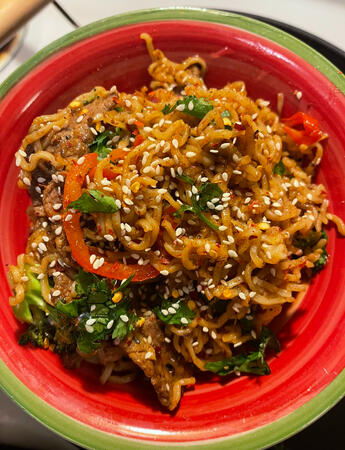 Beef stir-fry noodles with broccoli, peppers, zucchini, jalapeños, green onions, and cilantro