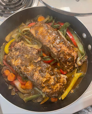 Steamed honey jerk salmon over peppers