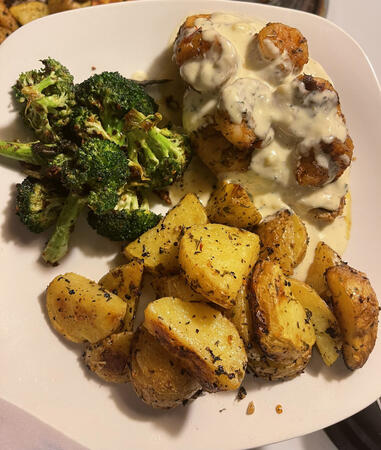 Pan-seared chicken and shrimp with broccoli, roasted potatoes, and gouda sauce